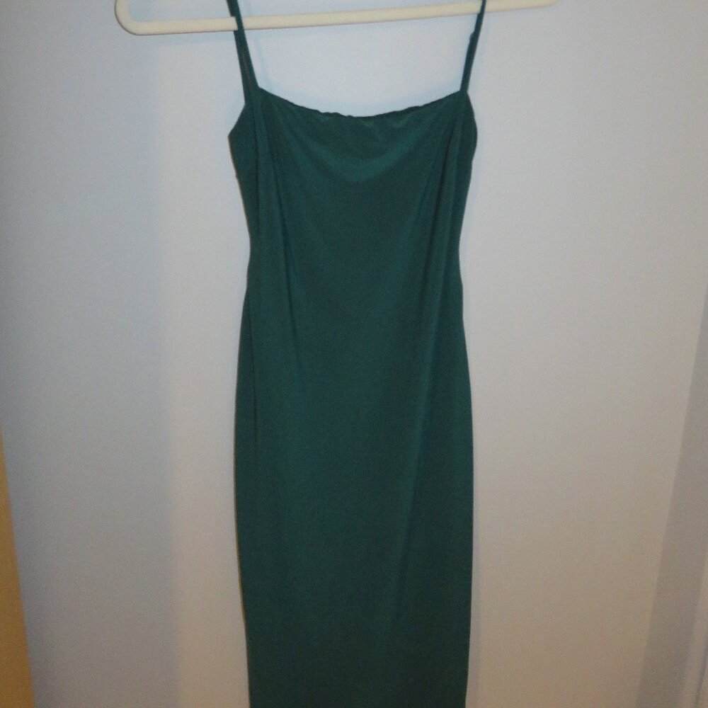 Sleeveless, backless, emerald green dress with tight fit